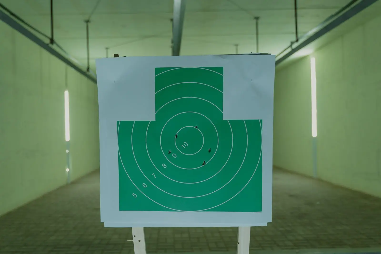 Target with bullet holes at an indoor range